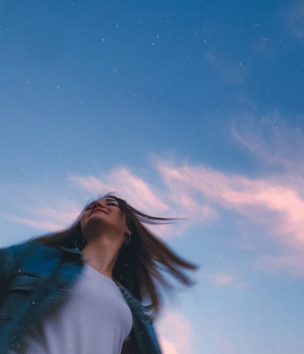 A woman feeling energetic and vibrant in a modern setting.